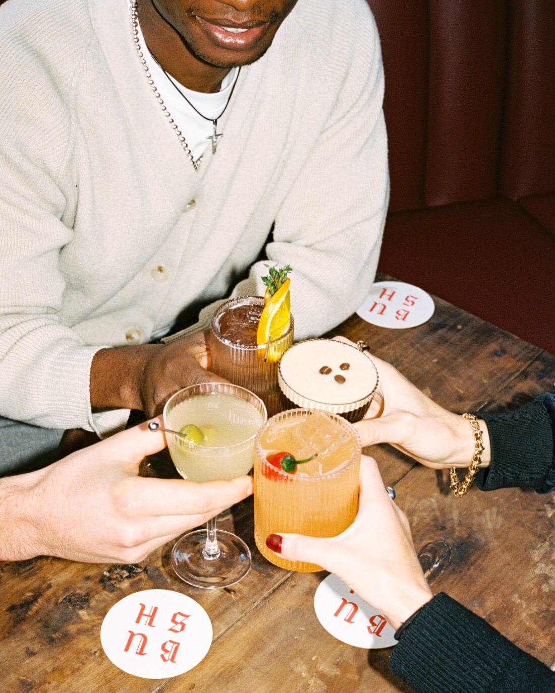 people drinking four cocktails