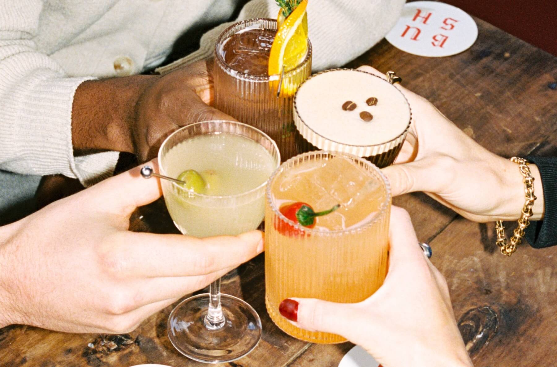 people drinking an array of cocktails