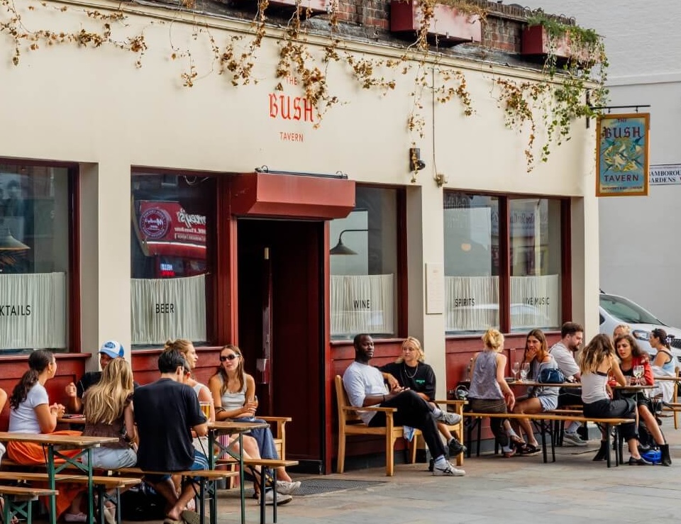 The Bush Tavern with people drinking and chatting outside