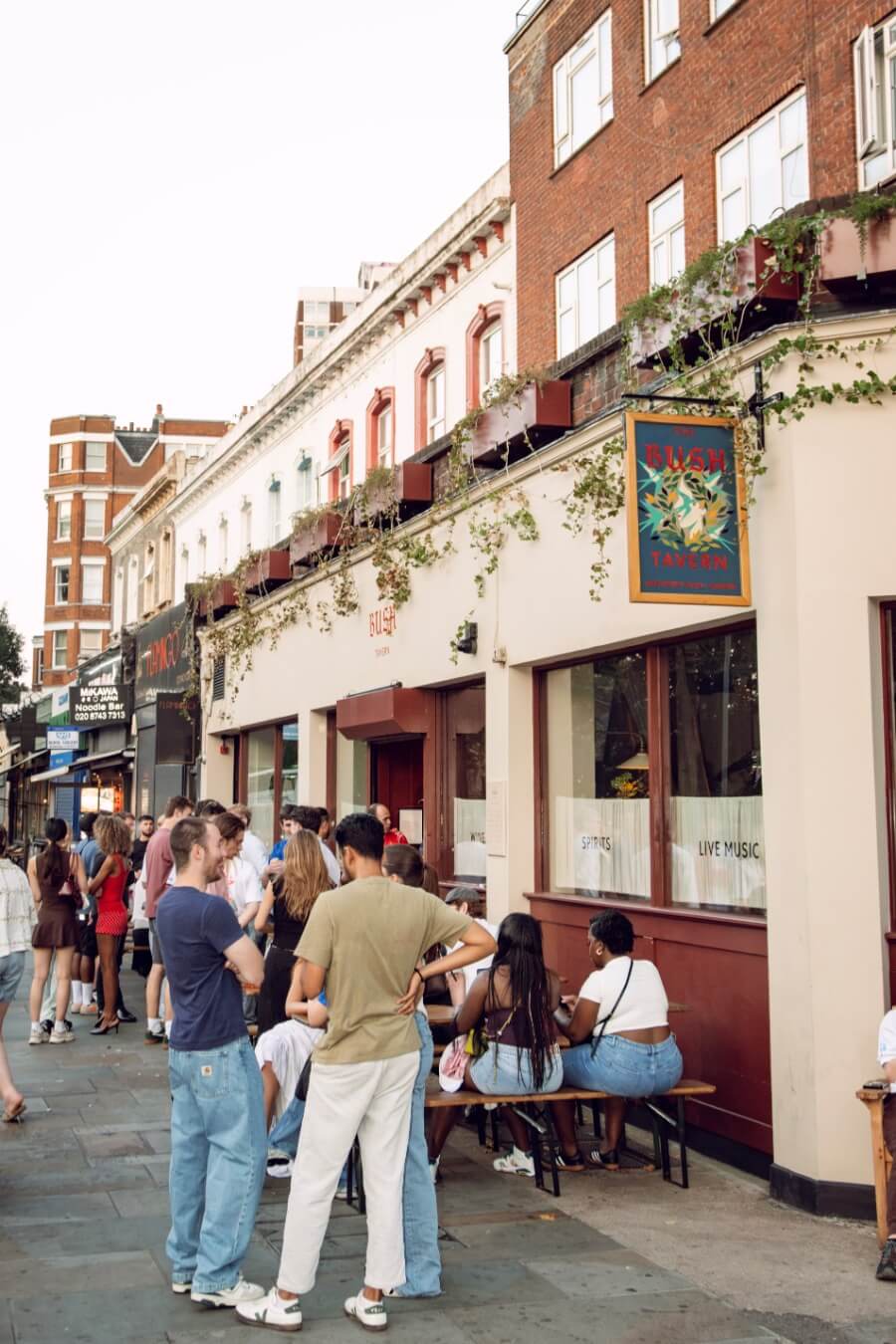 People drinking outside the Bush Tavern